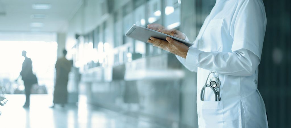 Healthcare and medicine. Medical and technology. Doctor working on digital tablet on hospital background; blog: medical technologies changing healthcare