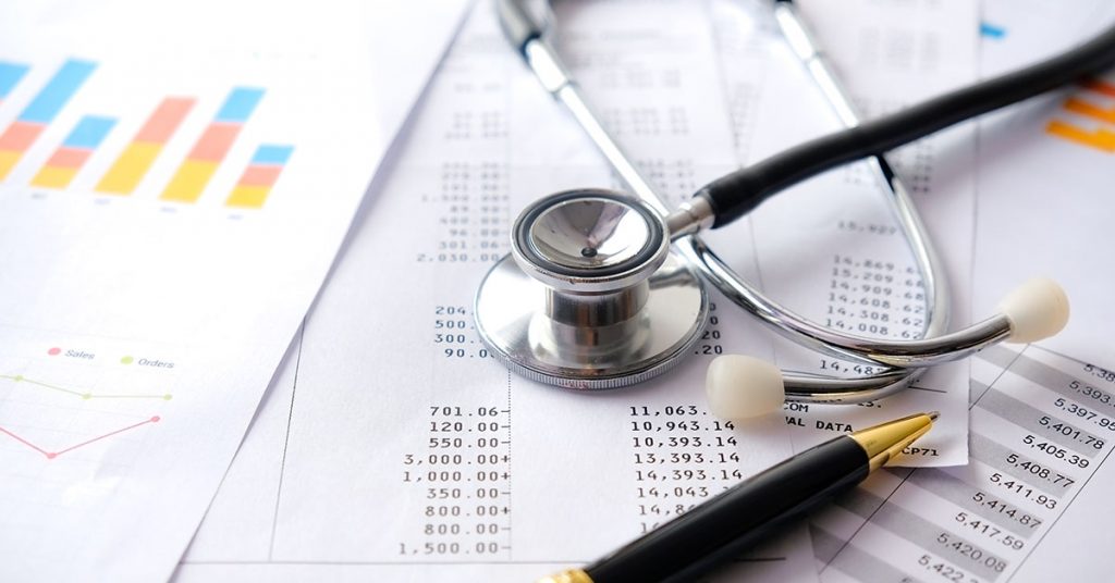 Stethoscope with Pen, Charts and Graphs, Finance, Account, Statistics, Investment, Analytic Research Data Economy Spreadsheet and Business Company Concept; blog: Biggest Practice Management Challenges & Their Solutions