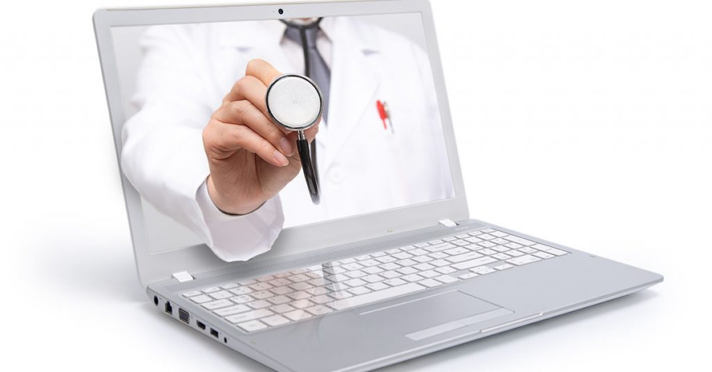 Telemedicine concept. Doctor with a stethoscope on the computer laptop screen; blog: Telemedicine vs Telehealth: What’s The Difference?