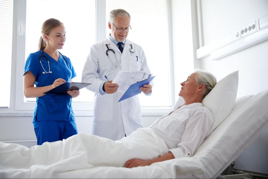 A doctor and nurse with a patient to represent Signs of a Quality Hospital